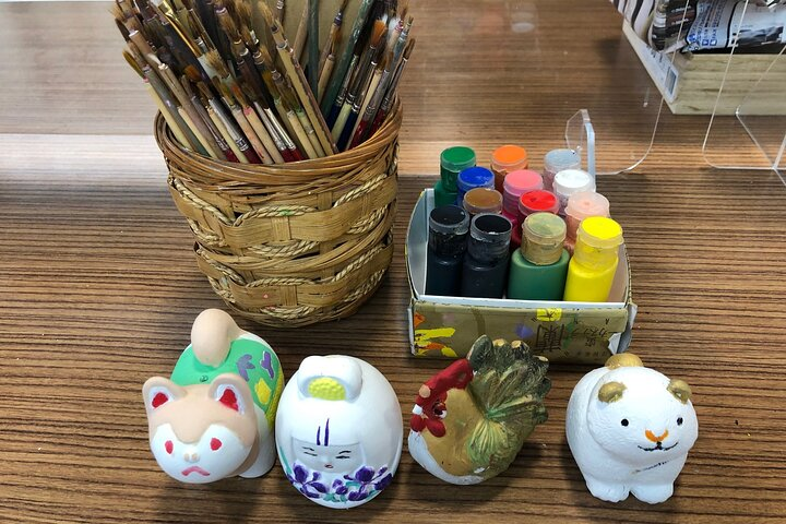 Immerse yourself in the art of Hakata Doll Painting surrounded by colorful paints and brushes. Experience the creative joy while crafting unique memories in Fukuoka’s historic setting.
