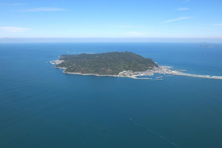 Discover Shikanoshima Island’s picturesque coastline and lush landscapes offering unique experiences like local cuisine cultural ceremonies and peaceful temple visits all within a serene island setting.