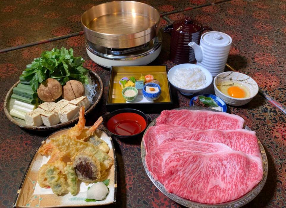 Experience the rich heritage of Osaka with Harijyu’s exquisite Wagyu Black Beef Sukiyaki beautifully presented alongside fresh ingredients inviting you to savor tradition in every delicious bite.