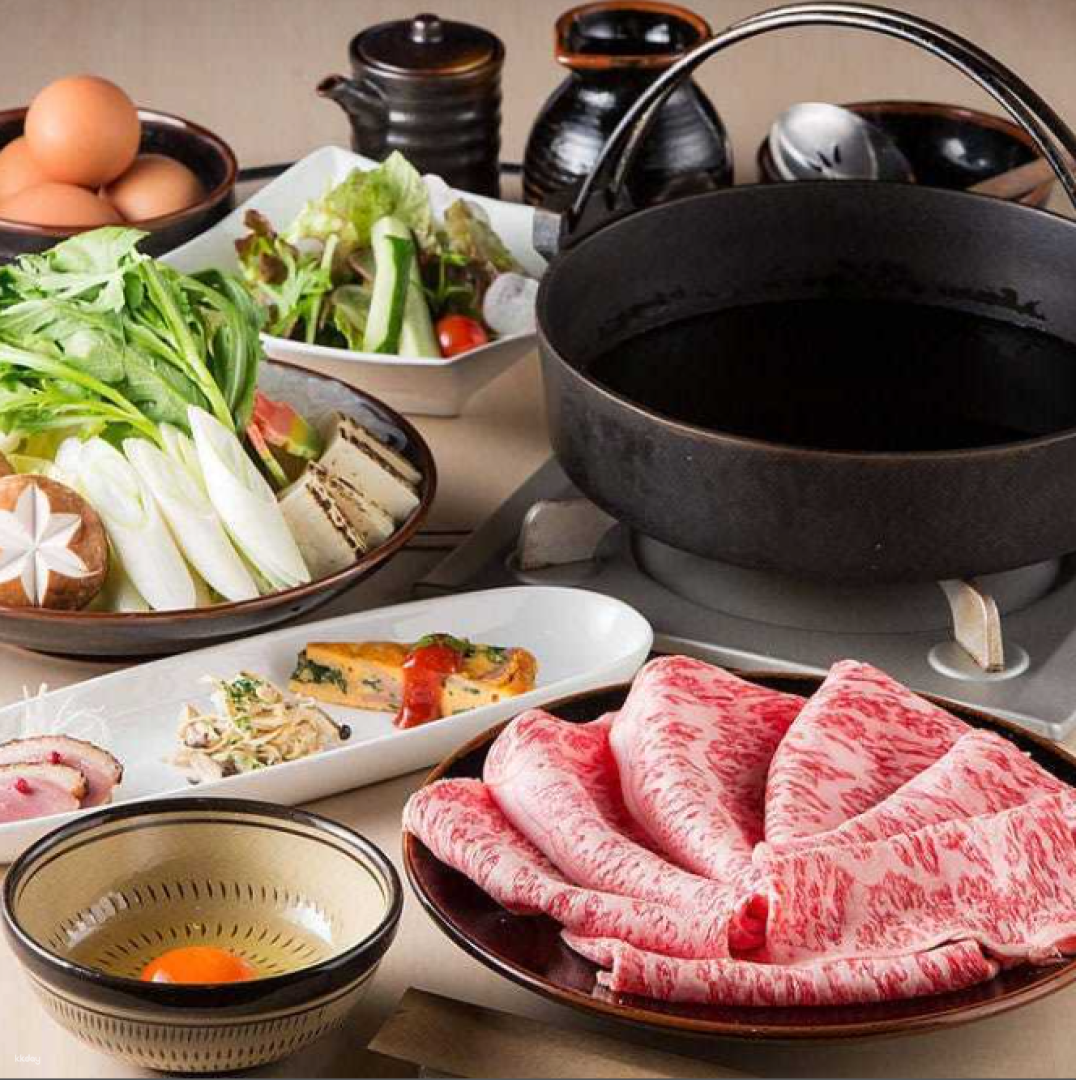 Indulge in a feast of Kuroge Wagyu beef and fresh seasonal vegetables perfect for savoring with friends amidst an inviting setting that elevates your dining experience in Fukuoka.