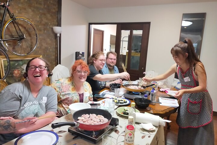 Experience the joy of making traditional Japanese dishes with friends uncovering the essence of home cooking in Tokyo while sharing stories about food culture and culinary traditions.