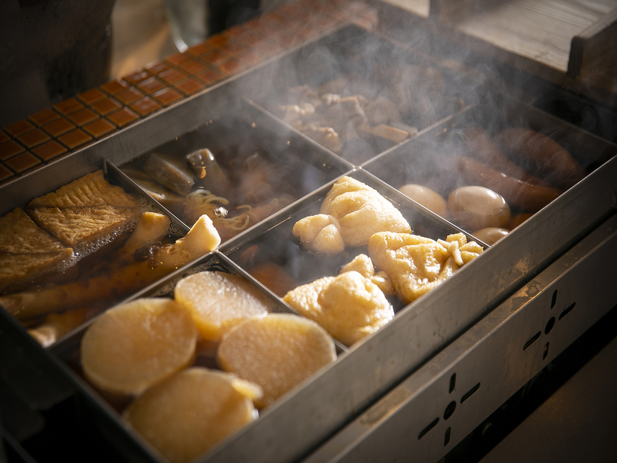 Savor the warmth of simmered oden showcasing a variety of delicate ingredients perfectly complementing the authentic flavors of Japanese sake at Sawara UMEKITA FLOOR in Osaka.