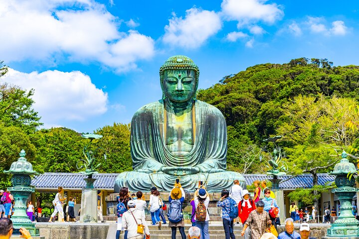 Experience the serene beauty of Kamakura's Great Buddha surrounded by lush greenery and the joyful energy of visitors. Explore ancient temples and picturesque gardens at your own pace with a private chauffeur.