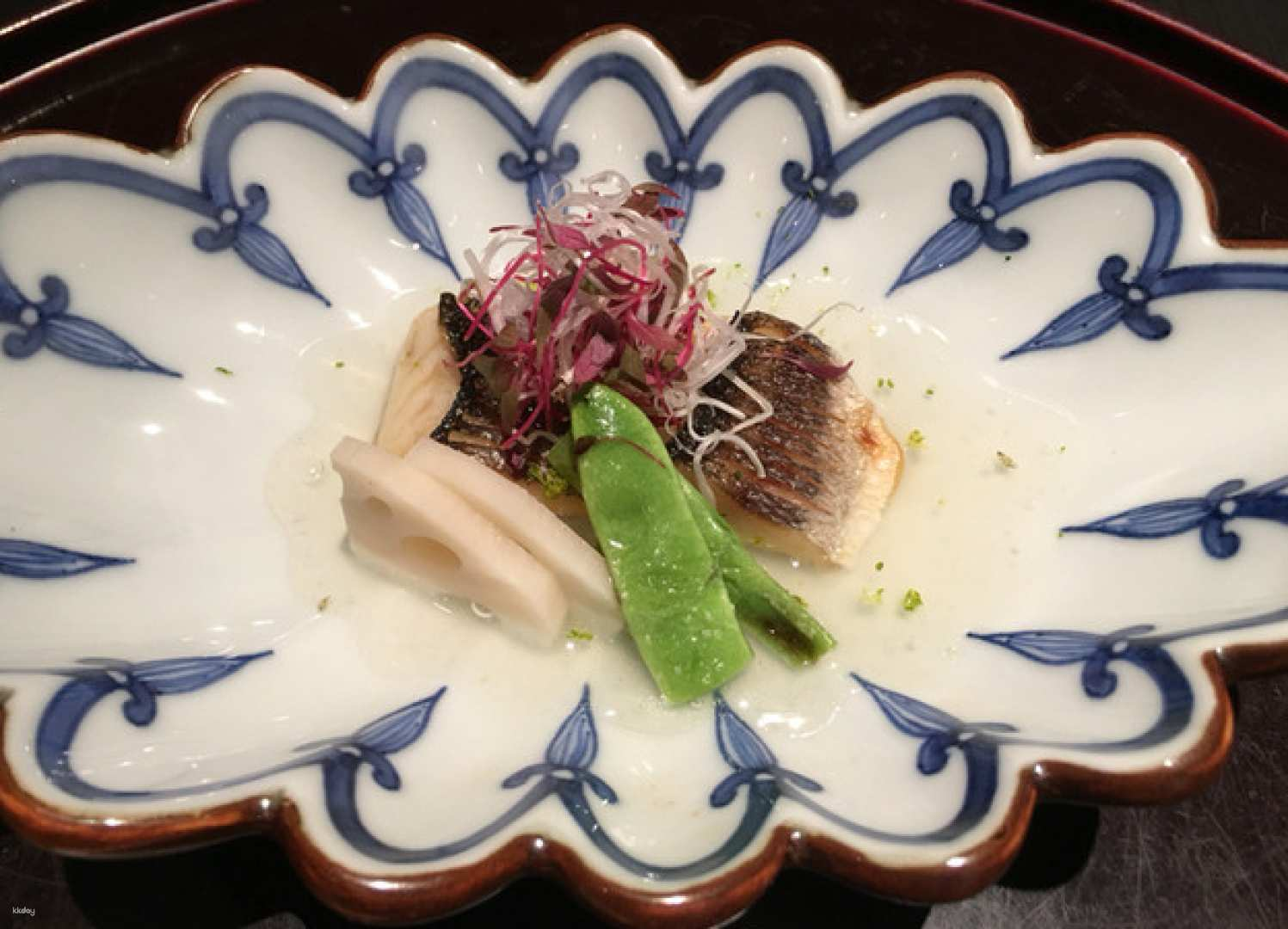 Experience exquisite kaiseki artfully presented on elegant porcelain showcasing fresh local ingredients in a refined setting that embodies the culinary excellence of Osaka’s prestigious Kitashinchi dining scene.