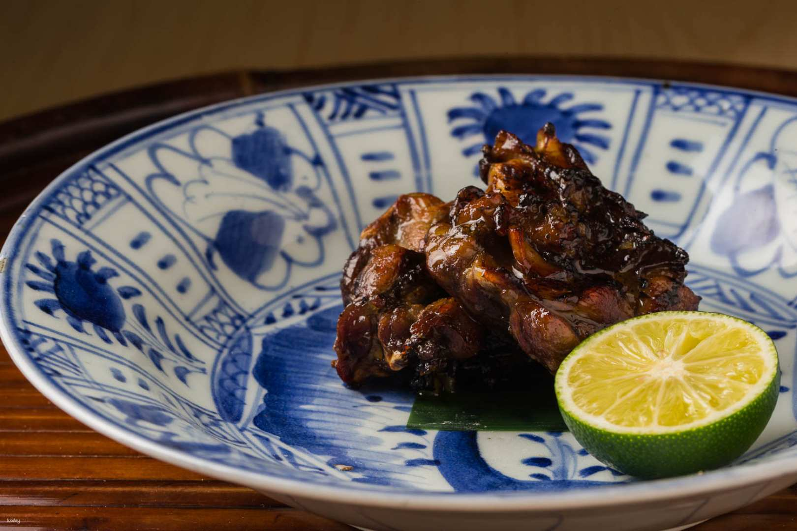 Delight in the exquisite flavors of charcoal-grilled dishes beautifully plated with a hint of lime inviting you to experience authentic Japanese culinary artistry in Tokyo's hidden gem.