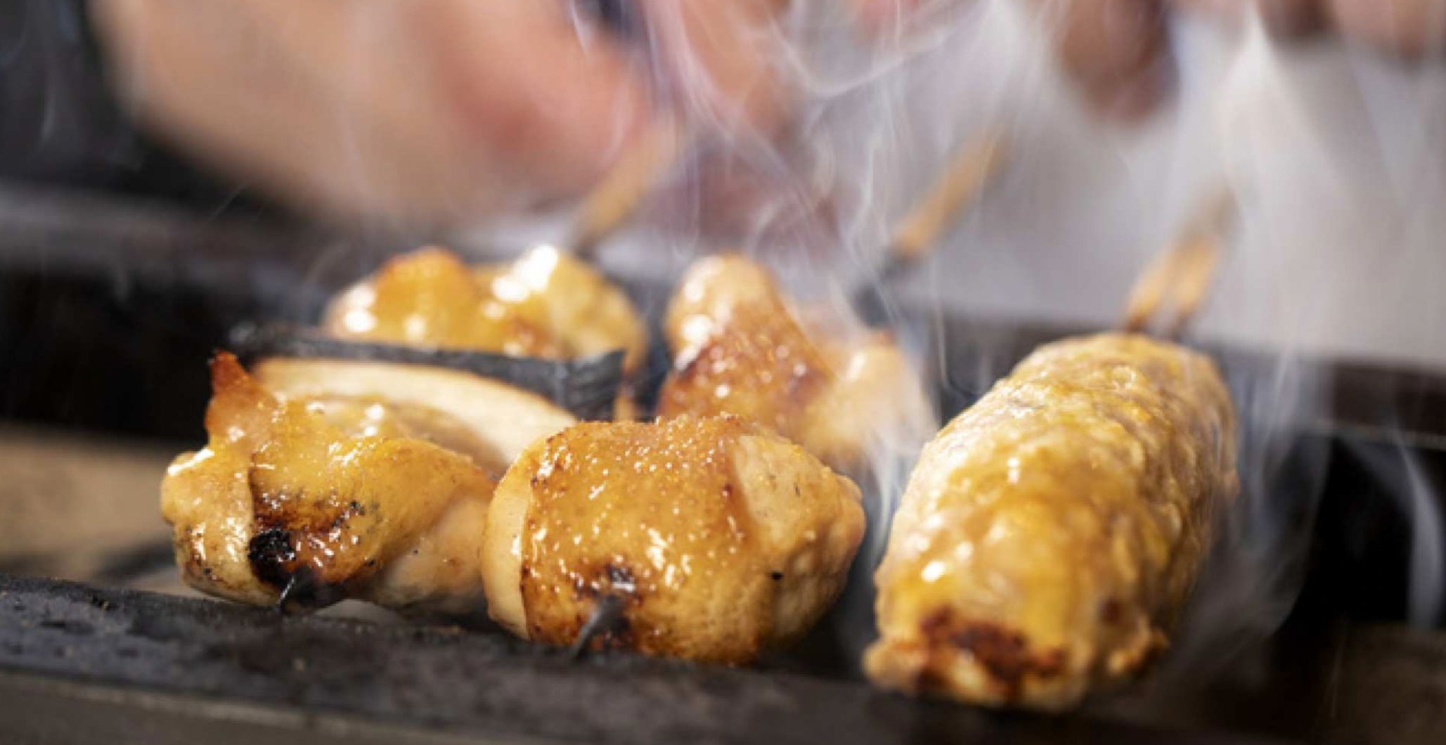 Savor the rich flavors of Black Satsuma Chicken grilled to perfection paired with exclusive Japanese sake in a chic setting that invites relaxation and culinary delight.