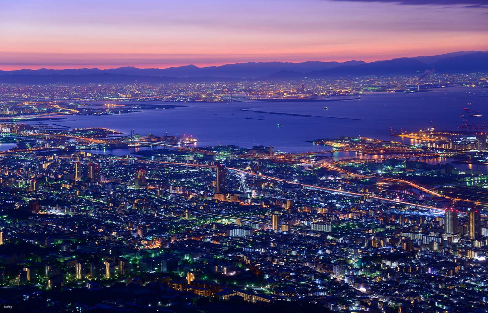 Gaze upon the stunning skyline of Kobe where the twinkling city lights meet the serene waters offering a perfect backdrop for a memorable evening getaway and delightful experiences.