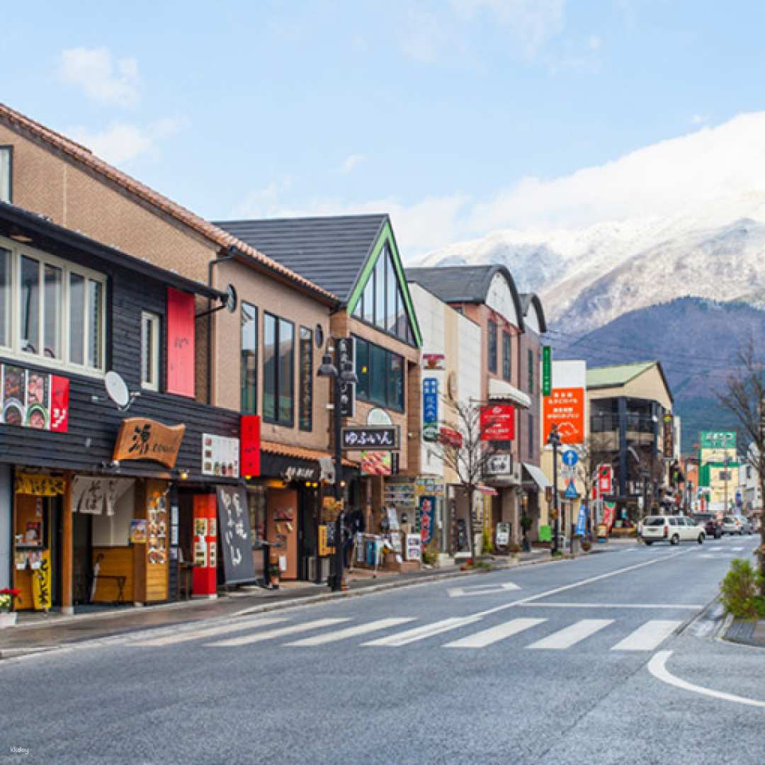 Explore charming streets lined with shops and cafes set against a stunning mountain backdrop perfect for soaking in local culture while capturing beautiful memories of your Japanese adventure.