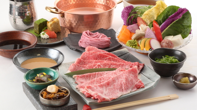 Savor the unique experience of shabu-shabu with premium Kuroge Wagyu beef and tropical sweet pork complemented by exquisite sauces and colorful seasonal vegetables perfect for a culinary adventure in Osaka.