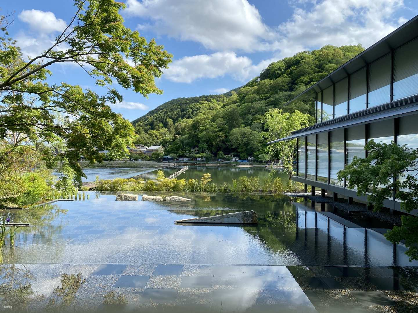 Experience serene views of lush mountains and tranquil water reflections at the Fukuda Museum of Art where art and nature seamlessly blend to enhance your exploration in Kyoto.