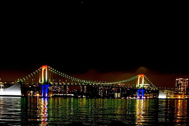 Experience the stunning nightscape of Tokyo Bay from a unique vantage point as shimmering lights dance on the water and iconic landmarks create unforgettable memories.