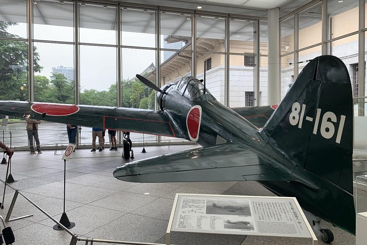 Explore iconic WWII relics like this historic aircraft while gaining insights into Japan's complex history at the Yushukan Museum where stories of sacrifice and resilience come to life.