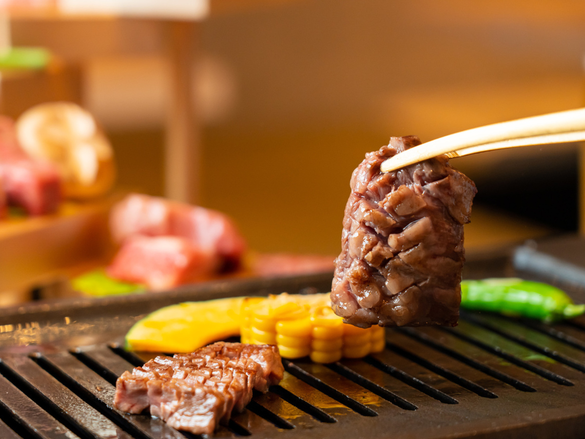 Indulge in the exquisite flavors of A5 rank female beef expertly grilled and served at a counter offering a unique dining experience in Tokyo's renowned Itamae Yakiniku style.