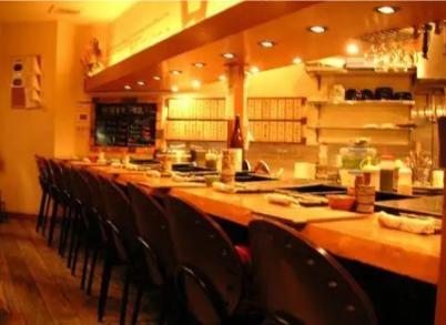 A cozy counter invites diners to explore the exquisite world of Wagyu beef offal at this unique Osaka yakiniku restaurant where every meal is an authentic culinary adventure.