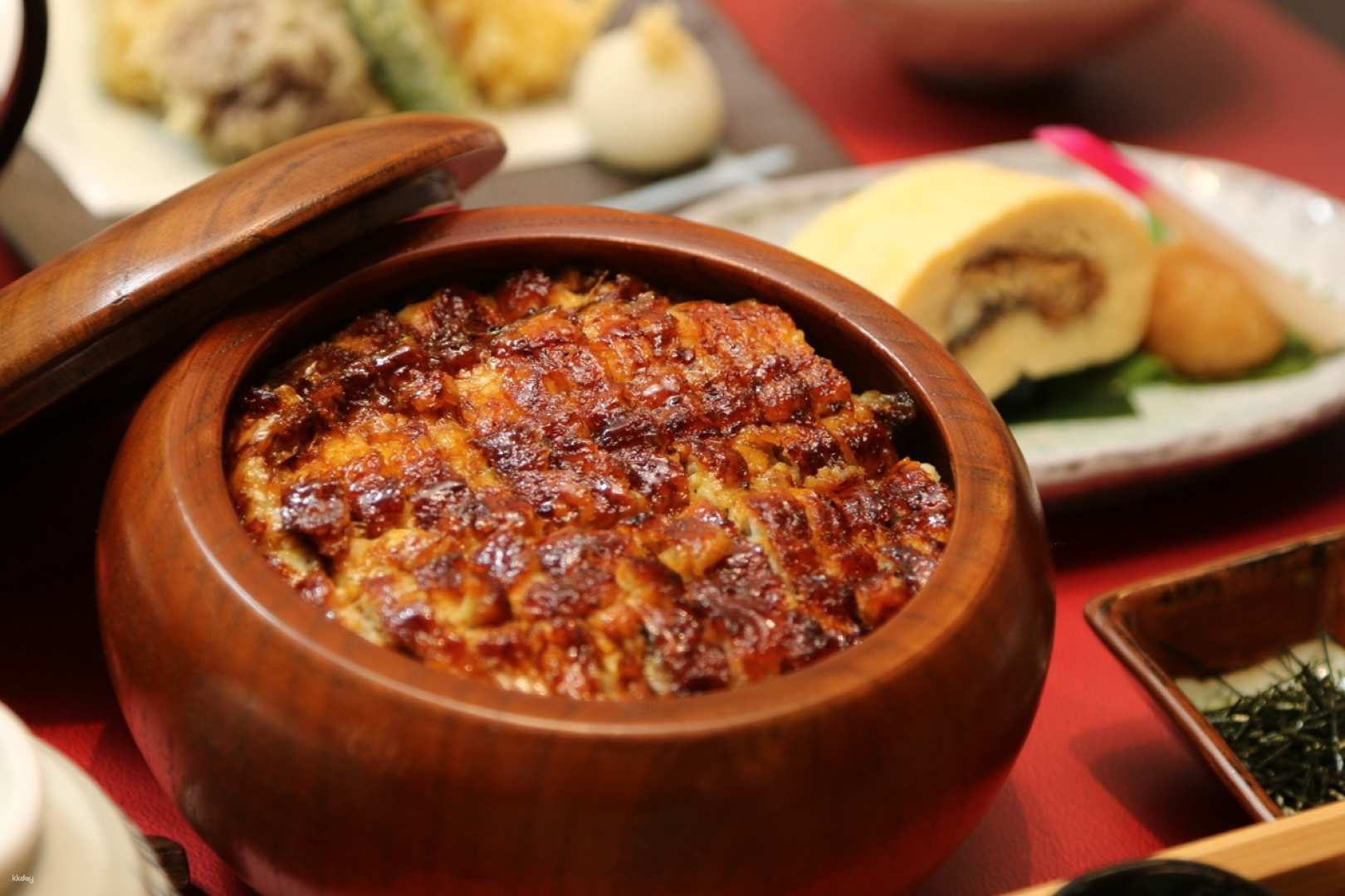 Savor the rich flavors of Nagoya's eel rice bowl crafted with freshly cooked rice and a secret sauce all while enjoying the serene design of the Unawa Izumi Store.