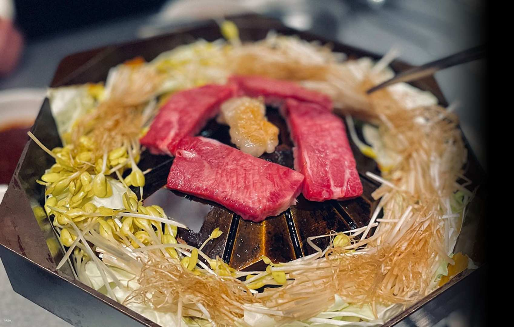 Savor the exquisite Ozaki beef served on a unique WAGYUJISUKAN pot showcasing culinary artistry and precision in every bite at Nagoya’s premium yakiniku destination.
