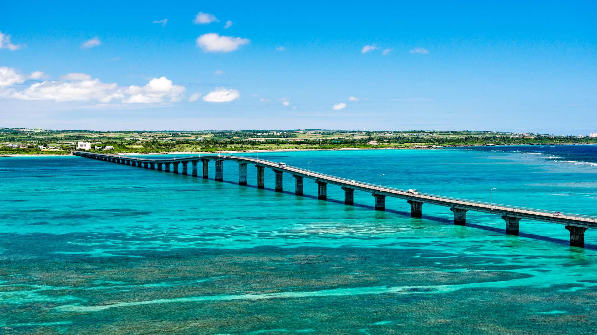 Explore the stunning turquoise waters of Kouri Island and traverse the scenic bridge perfect for connecting with nature and enjoying a day of unforgettable adventure in Okinawa.