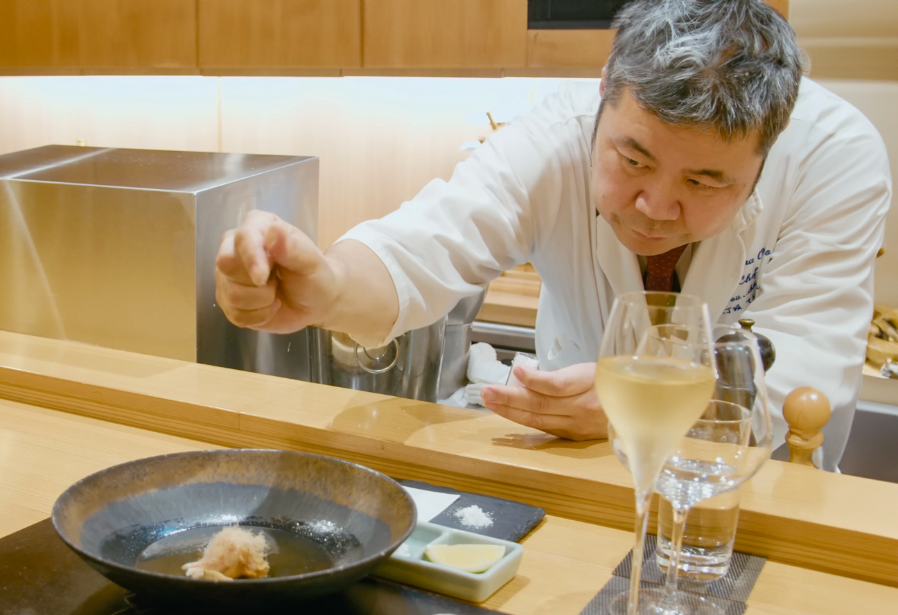 Experience a culinary journey as Chef Koichiro Shimura crafts a personalized tempura meal showcasing seasonal ingredients and the perfect sake pairing in an intimate dining setting.