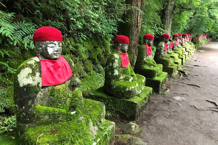 Experience serenity along the scenic route from Tokyo to Nikko where lush greenery and charming statues invite reflection and tranquility making every moment of your journey memorable.