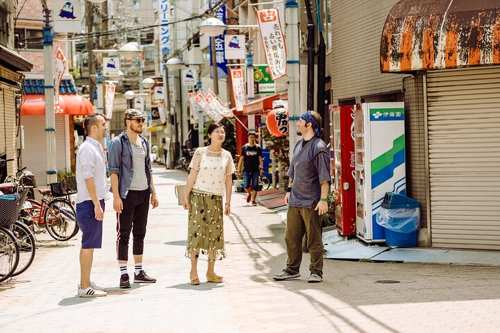 Explore Osaka's hidden gems with a local guide savoring delicious street food and wandering through charming neighborhoods while uncovering the city’s rich culture and history.