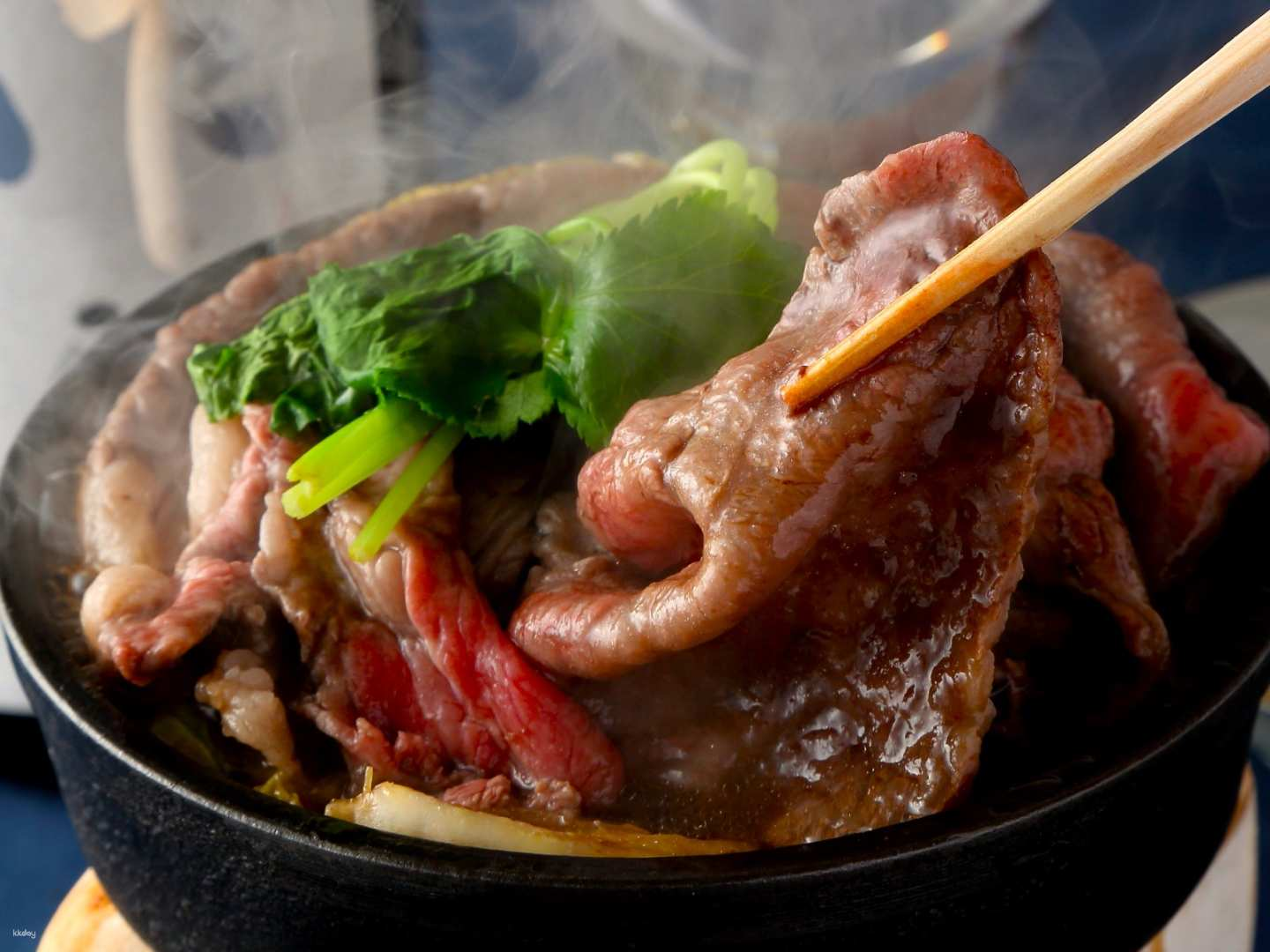 Experience the exquisite taste of A5 grade Kobe beef sukiyaki expertly crafted by seasoned chefs paired with a selection of rare sake in a private box setting in Osaka.