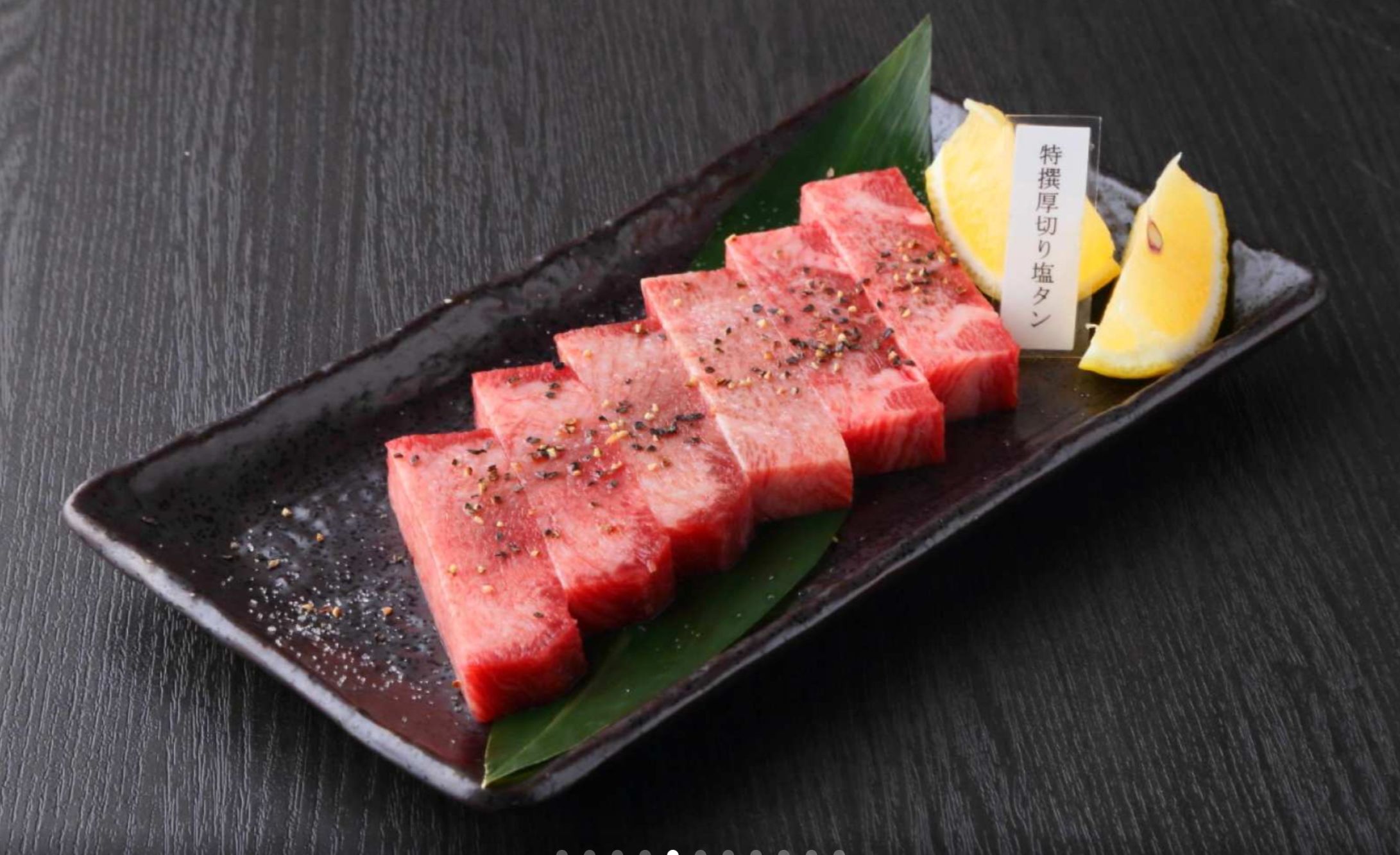 Experience the essence of Japan as you grill exquisite Kobe Wagyu beef savoring each bite's rich flavor and tender texture with friends in Osaka's inviting dining setting.