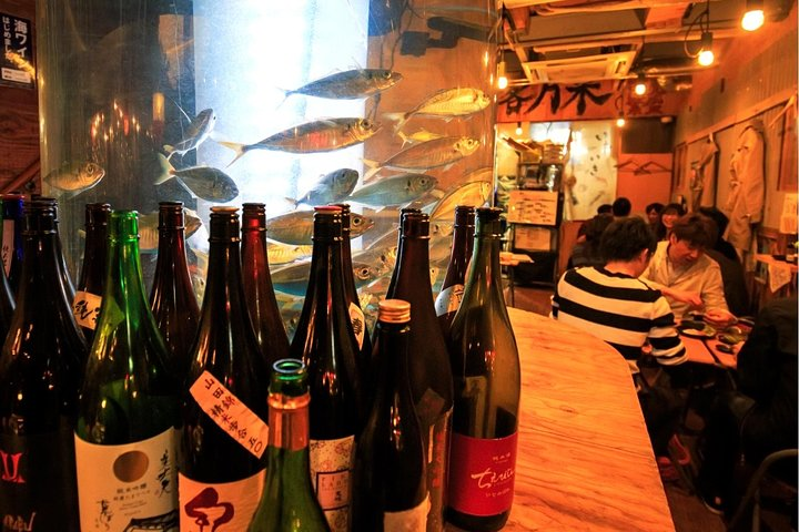 Indulge in Osaka’s culinary delights as you explore cozy izakayas and sip on local sake all while surrounded by the lively buzz of fellow night owls enjoying their evening feasts.