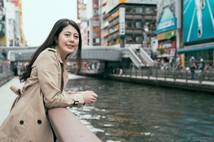 Experience the lively streets of Dotonbori from a scenic viewpoint where the charm of Osaka's blend of shopping dining and serene waterways invites exploration and discovery at every turn.