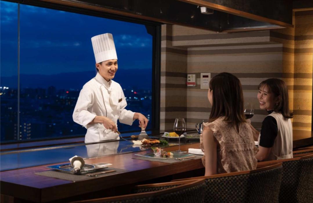 Savor the essence of Osaka as the master chef showcases culinary artistry enhancing your meal with stunning city views and top-notch service for an unforgettable dining journey.