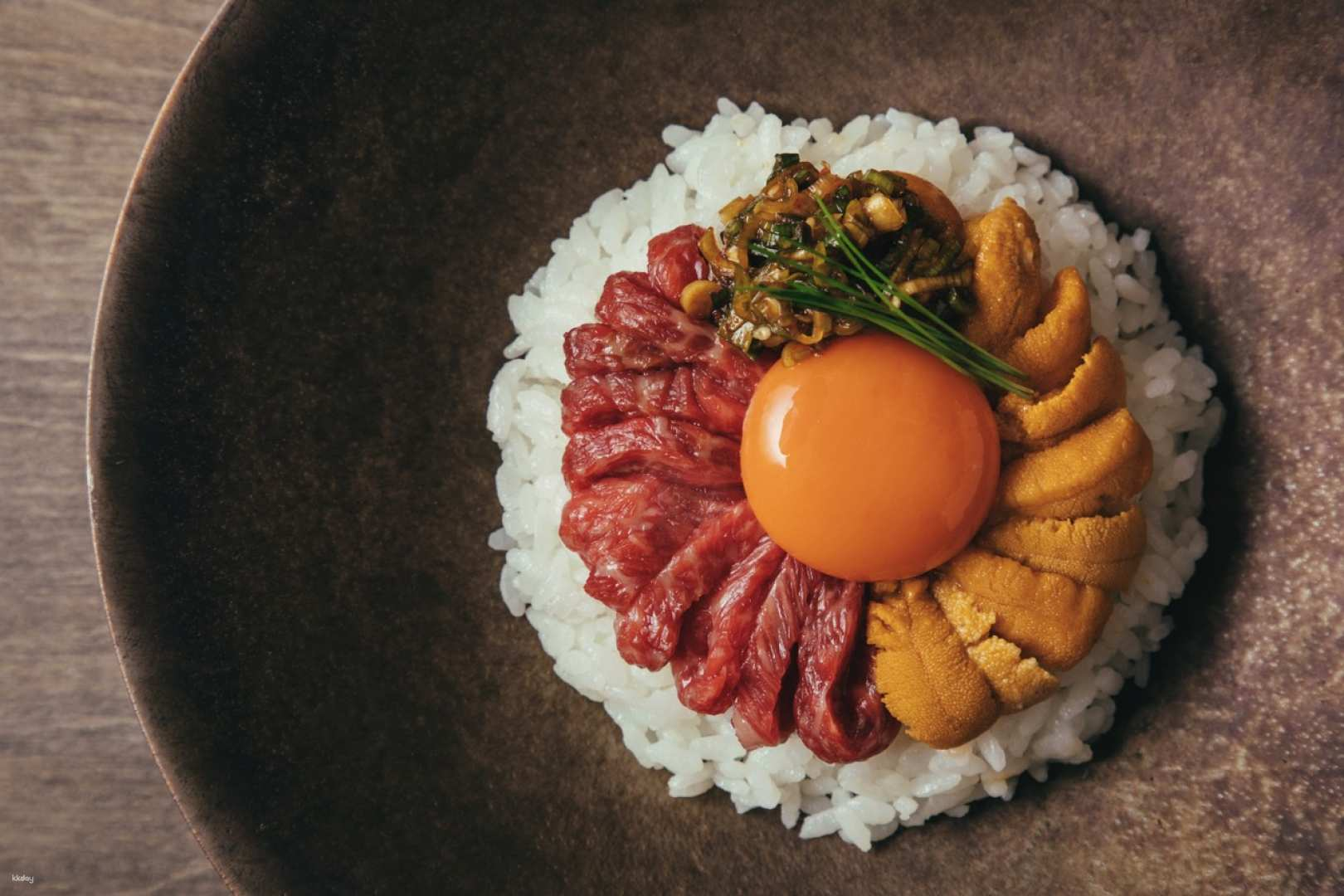 Savor the rich flavors of Premium Wagyu Yakiniku beautifully presented with delicacies like uni and egg delivering an unforgettable culinary experience unique to Ushigoro in Tokyo.