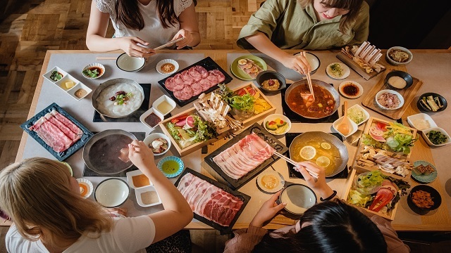 Immerse yourself in the culinary delight of shabu shabu where friends gather around premium meats and fresh vegetables savoring a unique dining experience in Nakameguro's vibrant food culture.