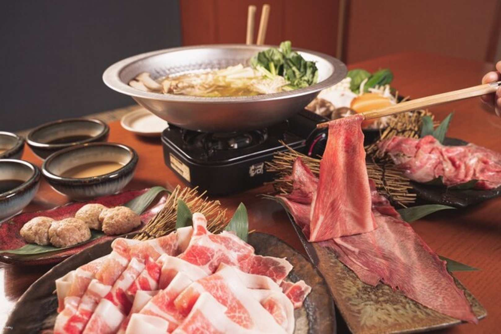 Savor the essence of Osaka with all-you-can-eat A5 Wagyu beef and Kishu plum pork shabu-shabu ideal for group feasts in a welcoming setting.