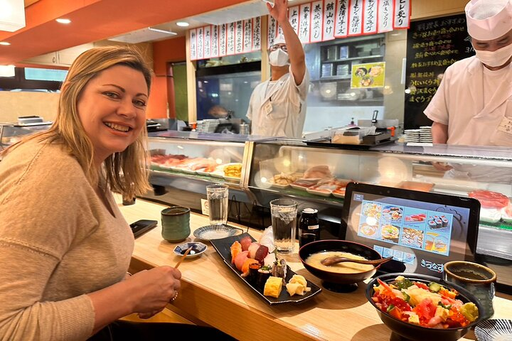 Experience authentic Japanese dining with locals savoring delicious sushi and fresh ingredients while enjoying lively interactions in a beloved Tokyo eatery. Immerse yourself in Tokyo's culinary culture.