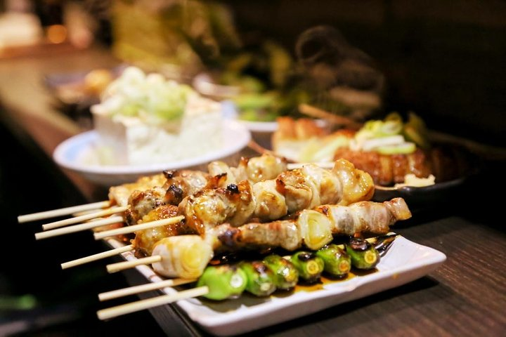 Savor the essence of Tokyo with delicious yakitori skewers and authentic ramen all while exploring Shinjuku’s historic food stalls—perfect for indulging in local culinary traditions.