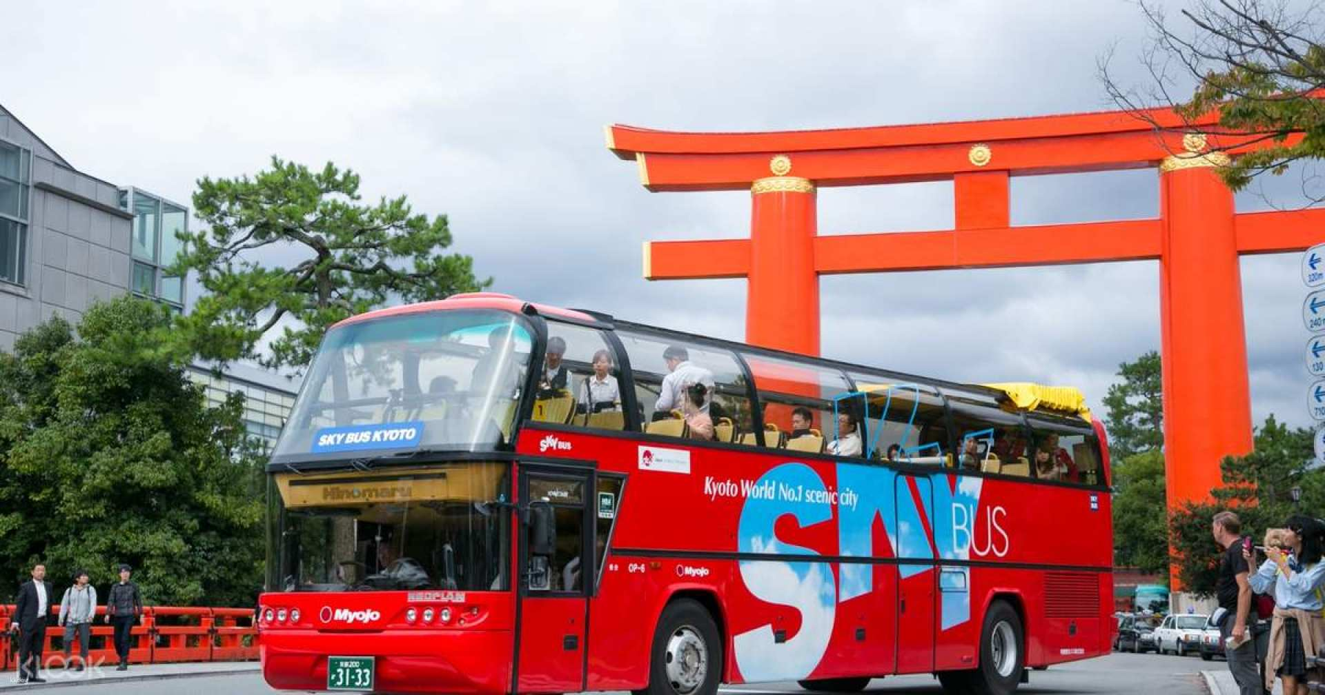 Discover the beauty of Kyoto from the open-air Sky Bus enjoying the sights and sounds of this historic city while learning about its iconic attractions through multilingual audio guides.