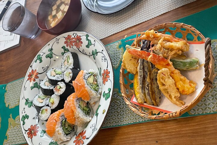 Experience the joy of creating authentic sushi rolls and crispy tempura in a cozy Tokyo home connecting with local culture and savoring delicious flavors together.