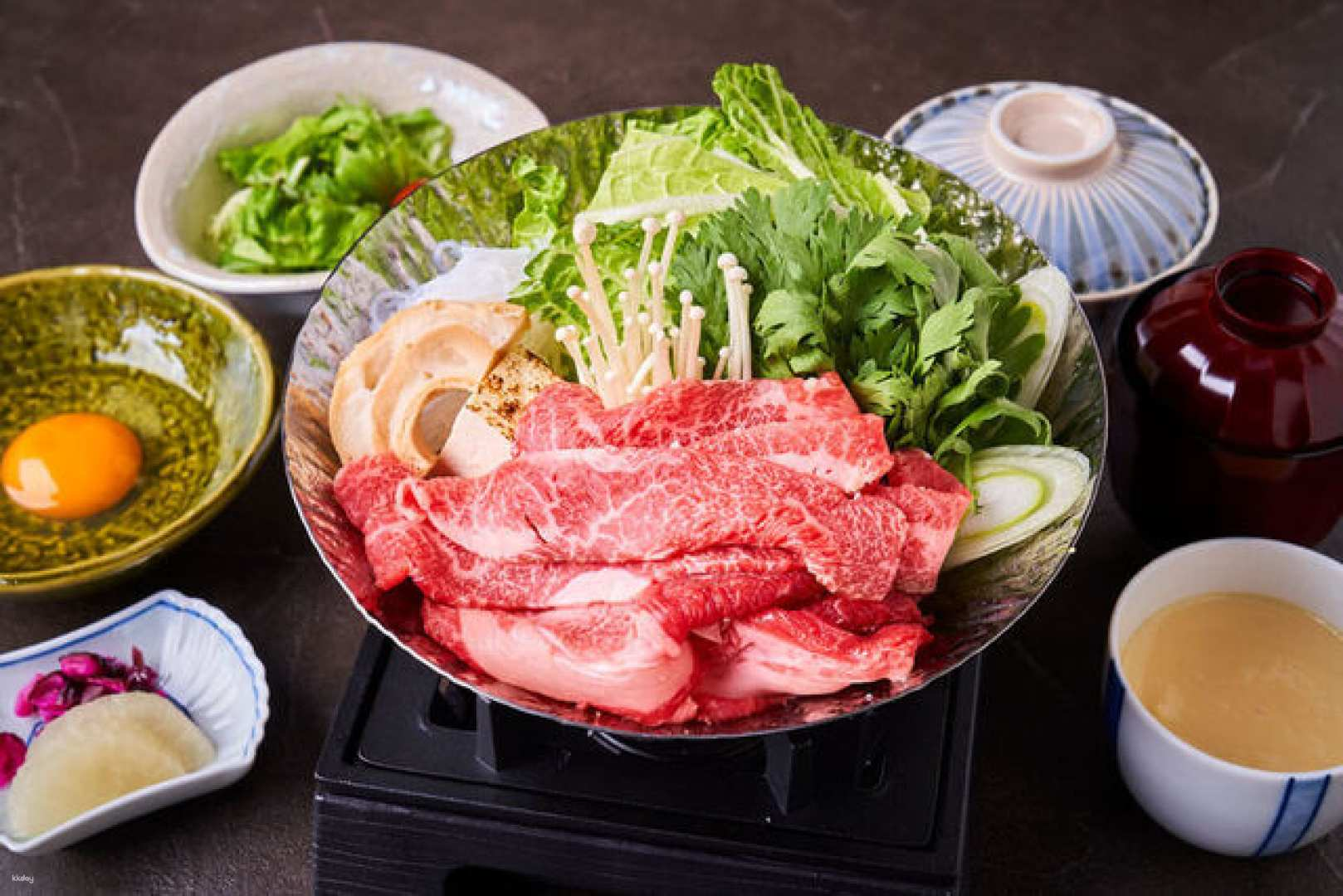 Savor the rich flavors of Chinya’s Sukiyaki featuring marbled beef and fresh greens all served in a stylish setting that echoes Asakusa's historic charm. Perfect for culinary adventurers.