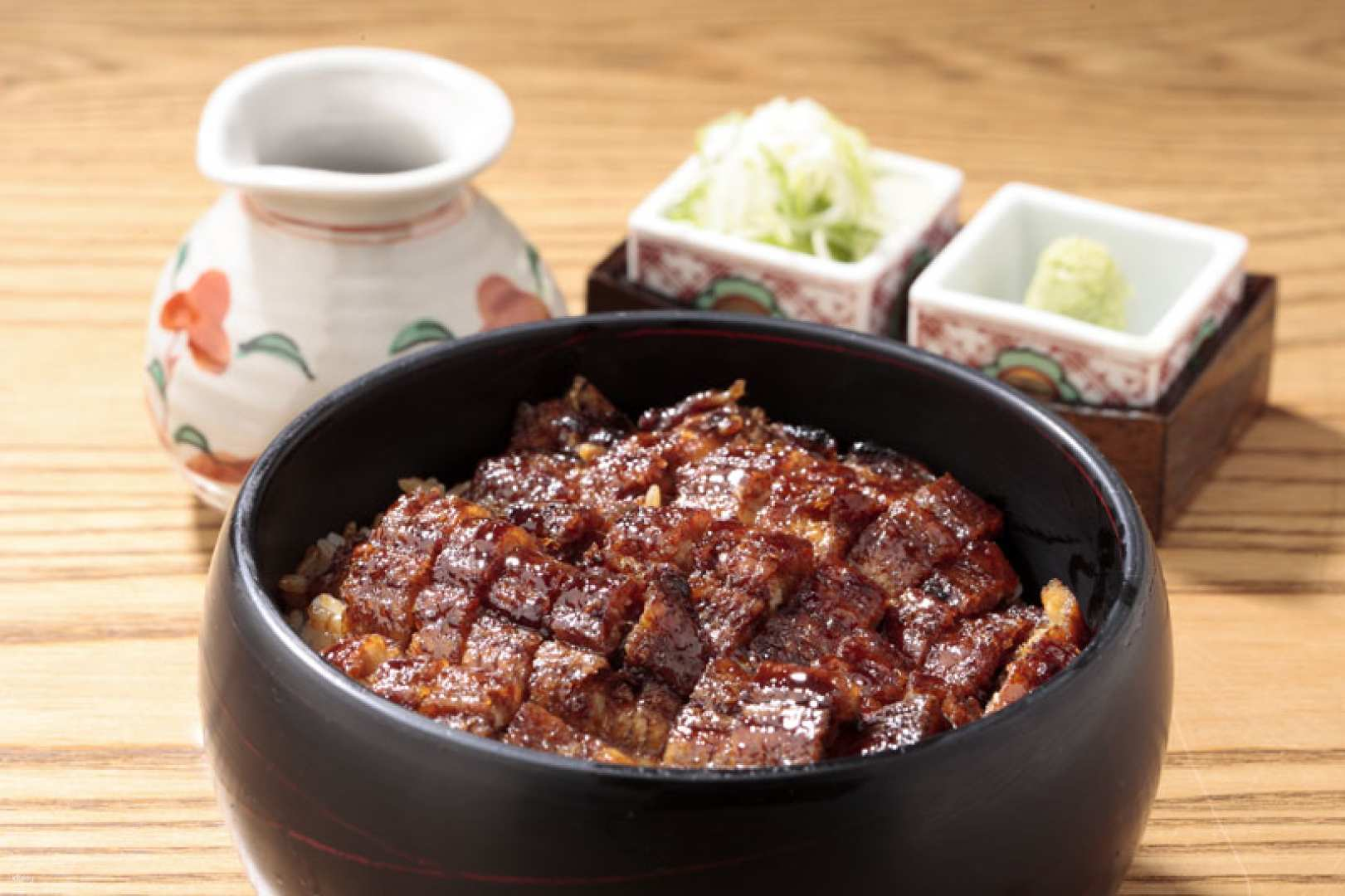 Indulge in the unique experience of savoring grilled eel rice perfectly complemented by traditional condiments all within the charming setting of Marronnier Gate Ginza 1 Tokyo.