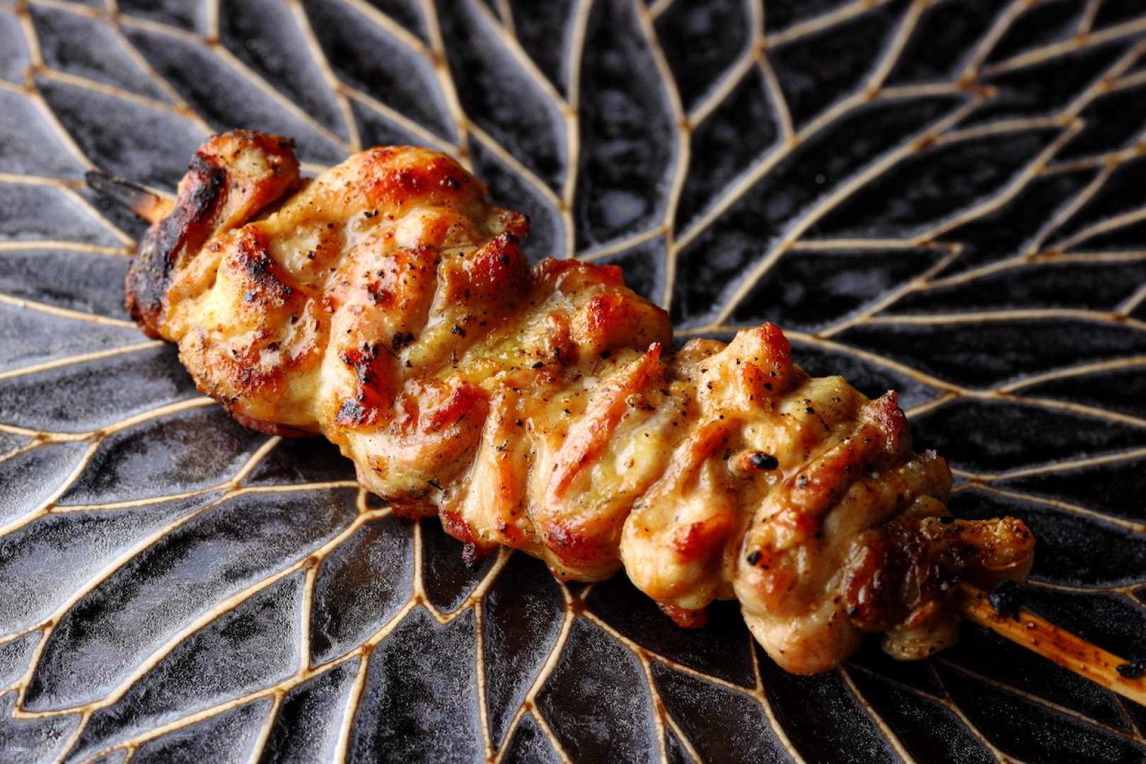 Indulge in expertly crafted yakitori made from premium Date chicken. Experience a blend of Italian winter truffles and skillful culinary artistry in a serene dining space.