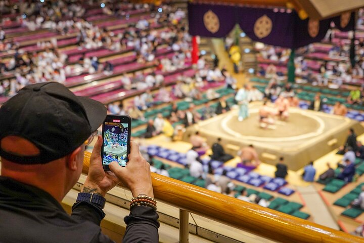 Experience the excitement of the Sumo tournament from a prime vantage point capturing the energy of the match and the rich cultural heritage of Ryogoku in every moment.