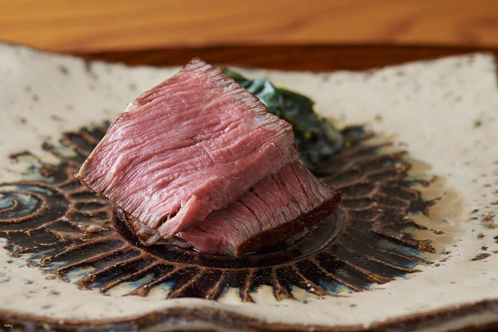 Savor the richness of A4 and A5 grade Wagyu beef artfully presented in a serene setting. Experience culinary craftsmanship as Chef Katayanagi prepares each dish right before your eyes.