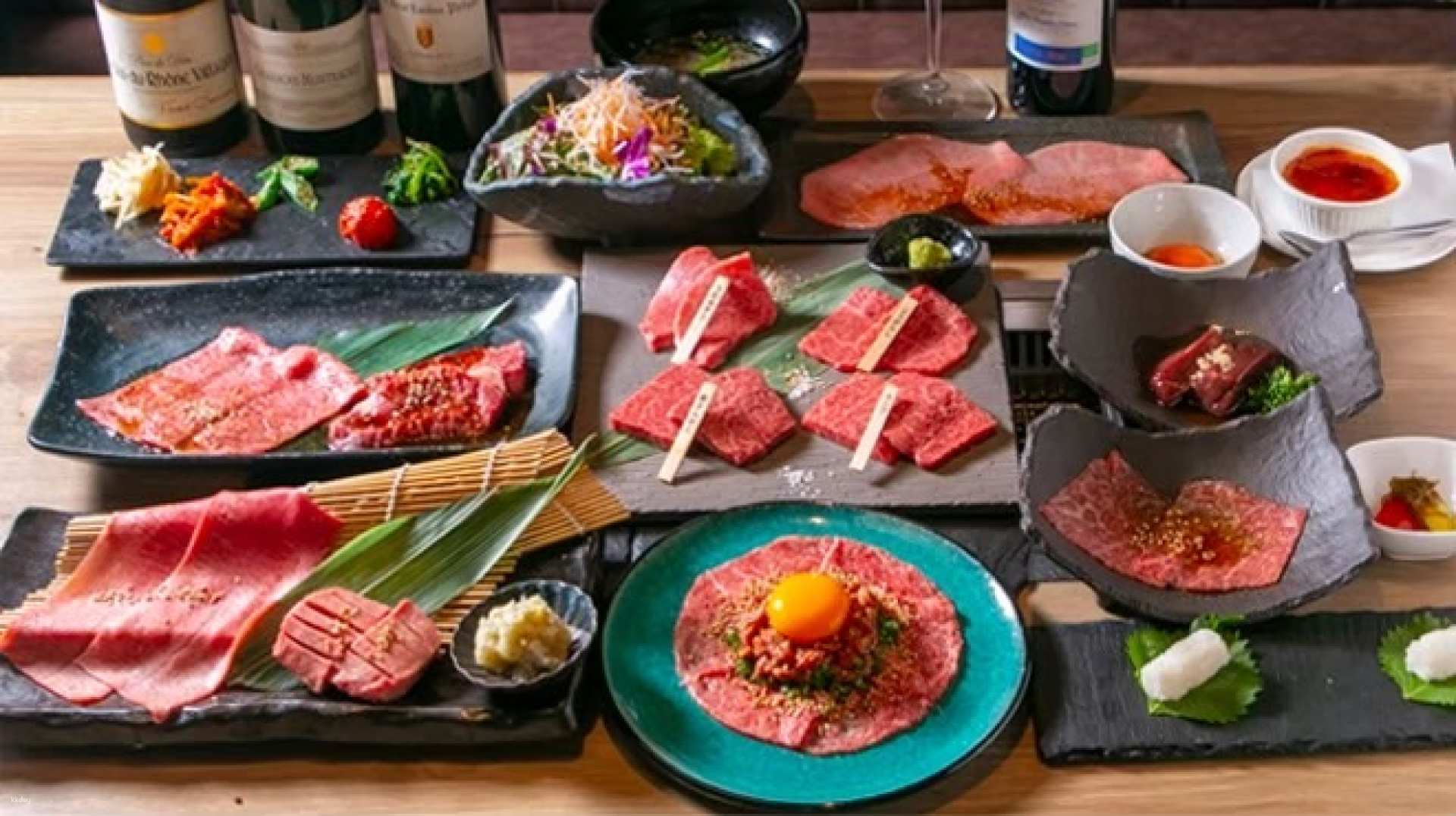 Indulge in expertly prepared Kuroge Wagyu beef with a selection of savory raw meat platters offering a unique dining experience for adventurous food lovers in Tokyo.