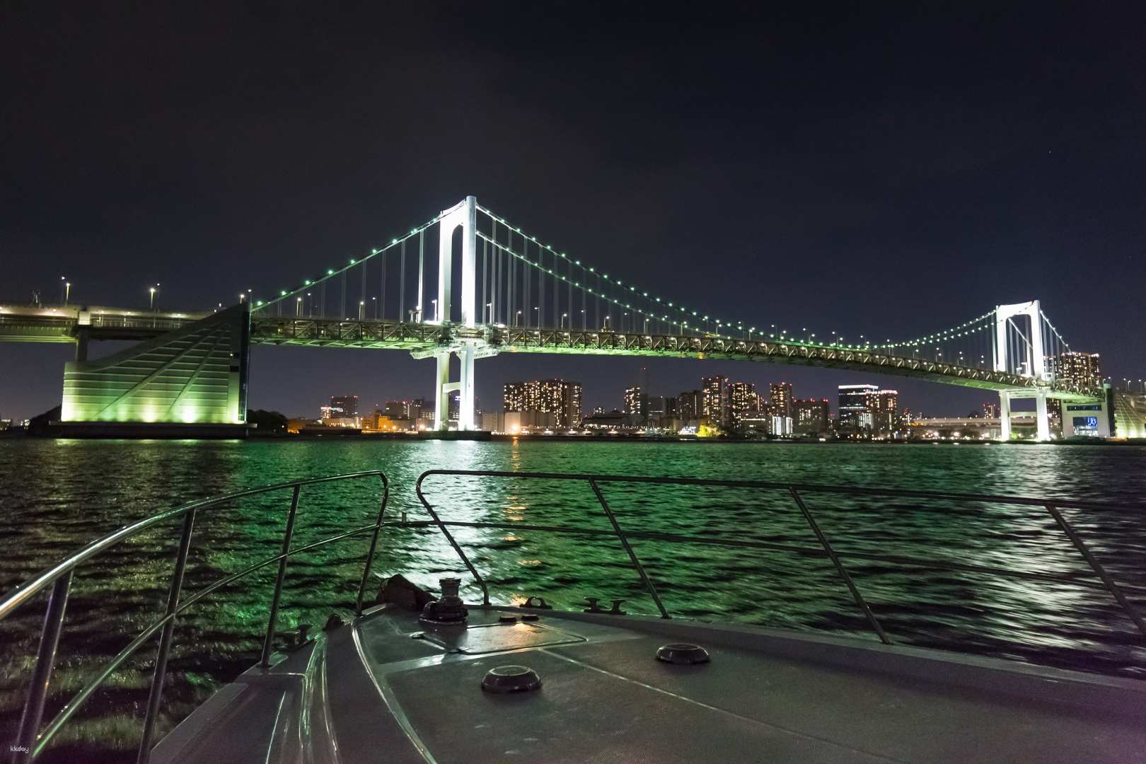 Sail through Tokyo's nightscape witness the illuminated Rainbow Bridge and striking city skyline while savoring snacks and drinks for an unforgettable shared cruise experience.