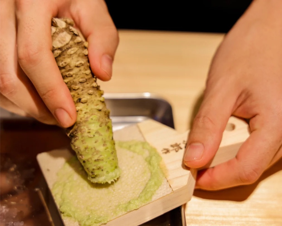 Immerse yourself in the art of sashimi preparation honing your knife skills and exploring the delicate process of grinding fresh wasabi in a professional kitchen setting.
