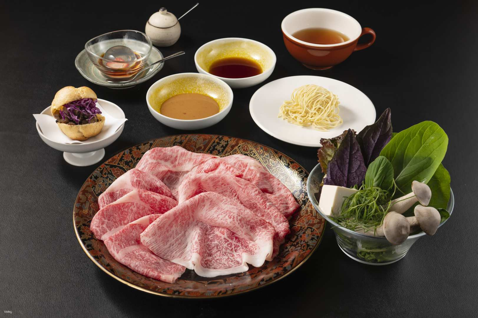 Indulge in the exquisite taste of Kuroge Wagyu beef shabu-shabu perfectly paired with seasonal vegetables all while enjoying stunning views of Shibuya Crossing from a stylish dining space.