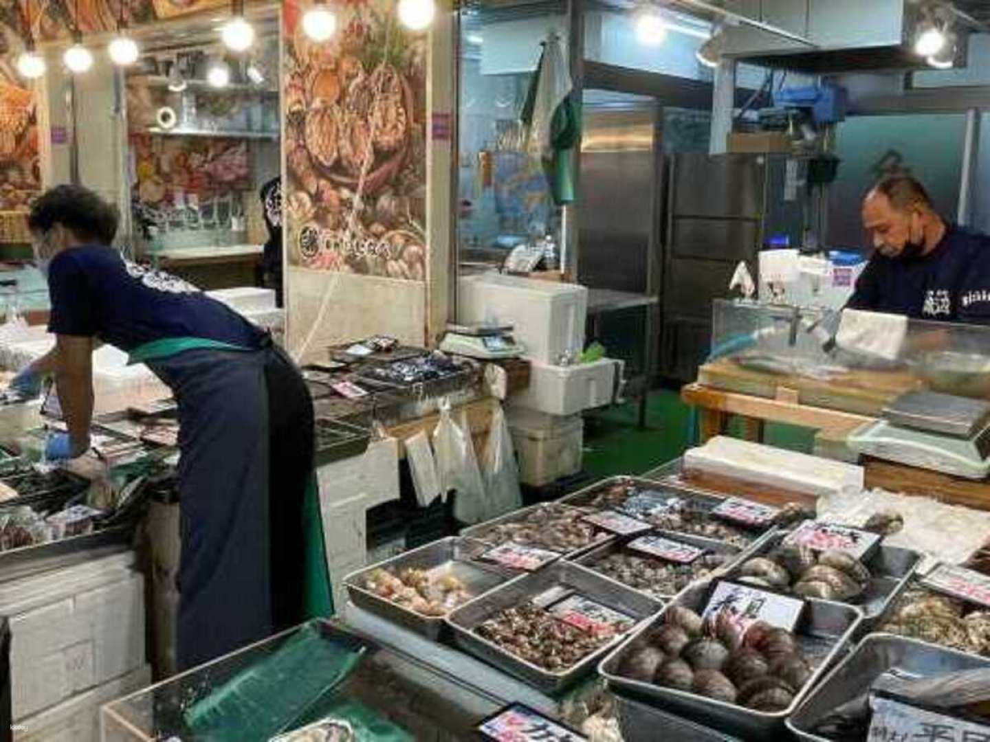 Discover the charm of Tsukiji Outer Market where local vendors showcase fresh seafood and immerse yourself in a delightful sake tasting while connecting with the community.