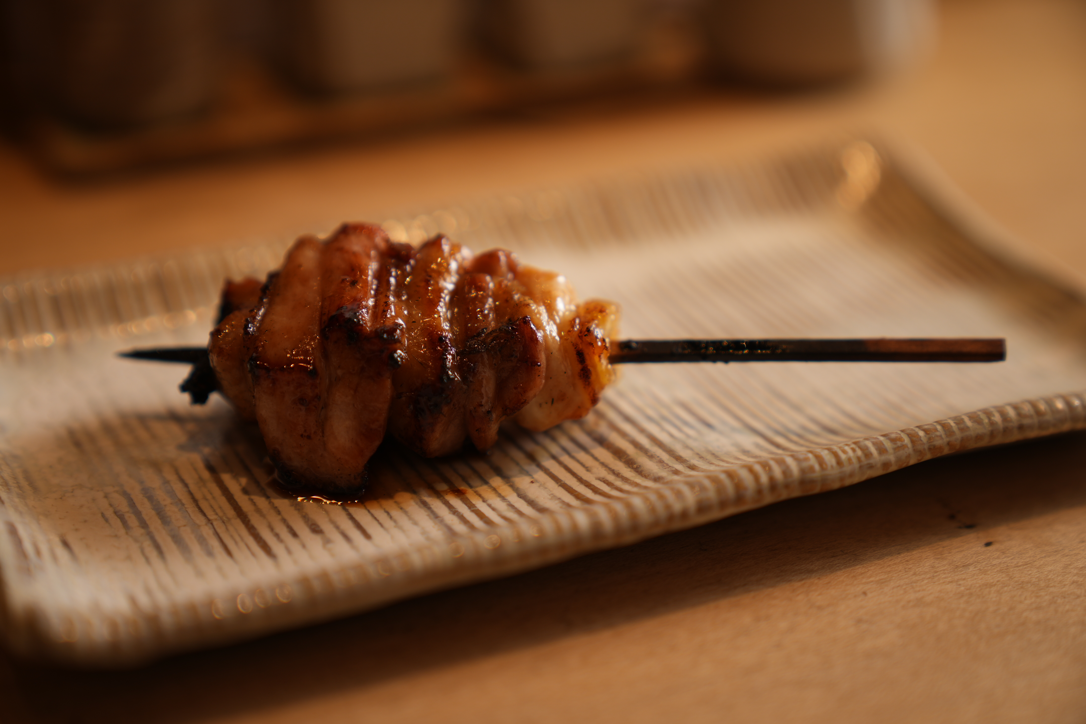 Experience the refined elegance of yakitori mastery with each meticulously grilled skewer showcasing the authentic flavors of Datedori chicken in a distinguished dining setting.