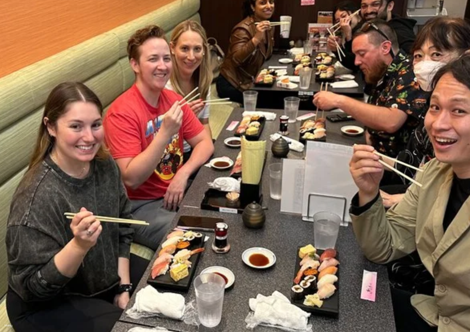 Gather around a table of sushi lovers as you dive into Shibuya's culinary delights savoring diverse flavors and sharing joyous moments with fellow food enthusiasts on a memorable journey.