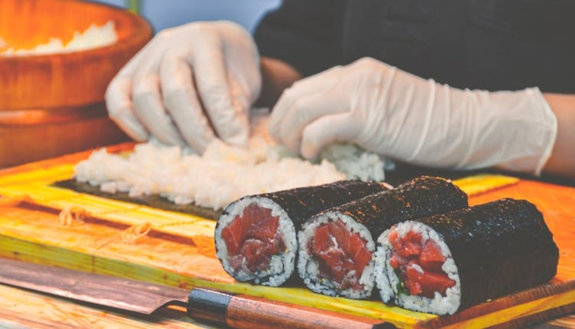 Savor the authentic flavors of Japan with expertly crafted sushi as skilled hands create delicious rolls from the freshest seafood at the iconic Tsukiji Fish Market in Tokyo.