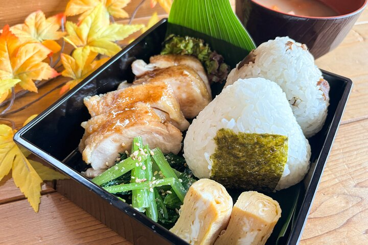 Savor the essence of Japanese home cooking with teriyaki chicken onigiri and tamagoyaki perfect for a shared meal that reflects Tokyo's culinary heritage and tradition.